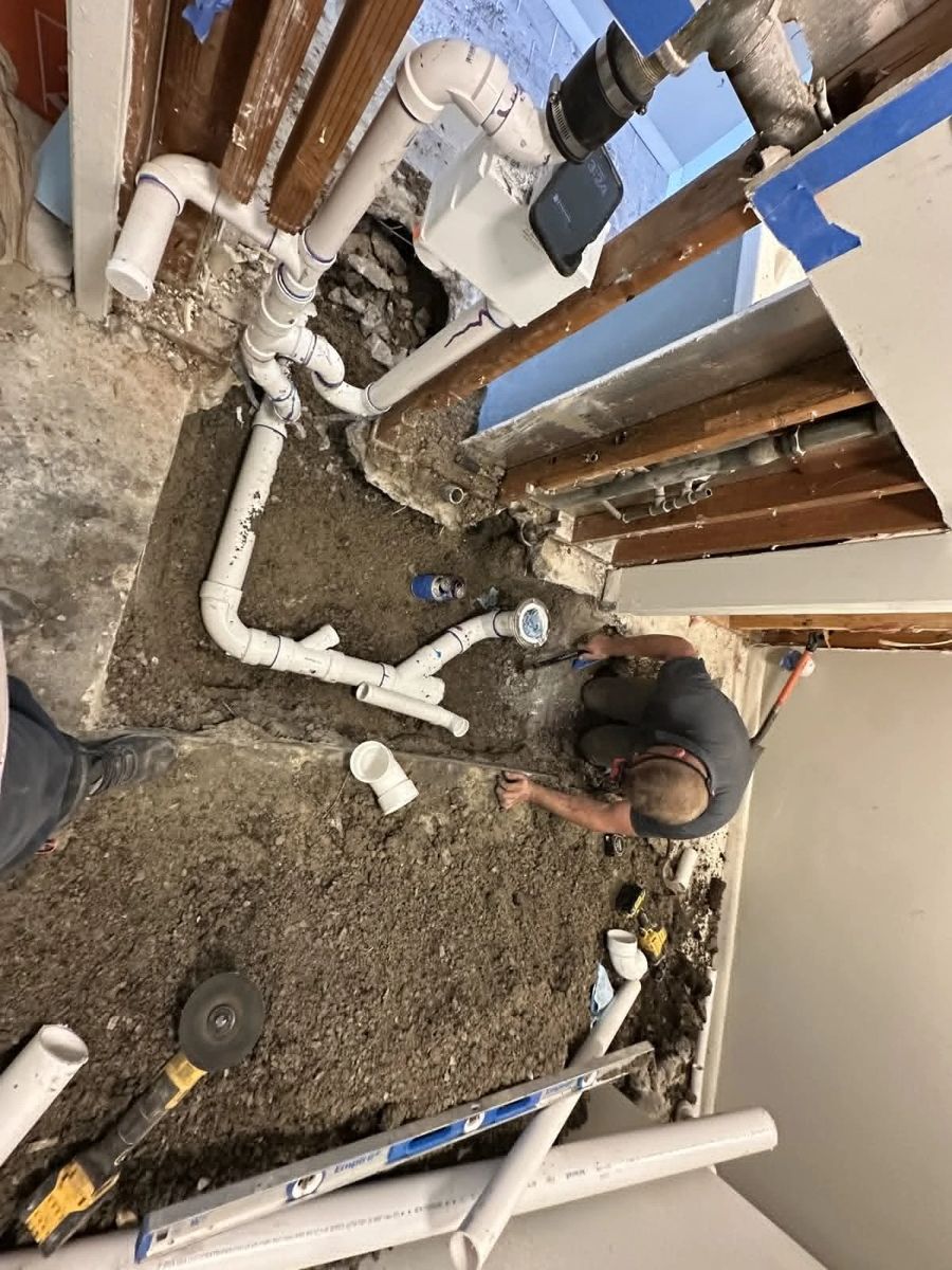 Drain piping being fitted in an opened floor slab